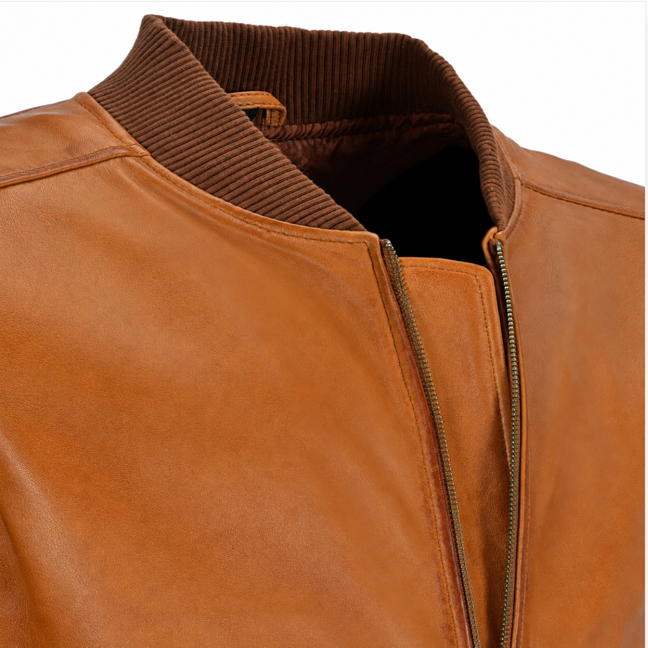 Close-up of a tan leather jacket with a ribbed brown corduroy-style collar and a front zipper, shown against a plain white background.