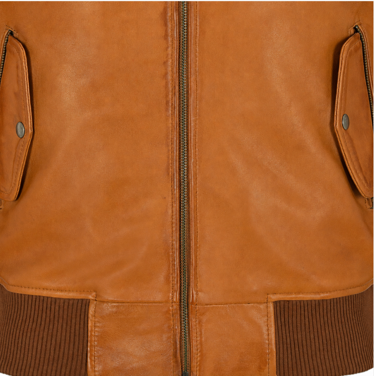 Close-up of a tan leather jacket with a center zipper, flap pockets with metal snap buttons, and dark brown ribbed knit trim at the hem and cuffs.